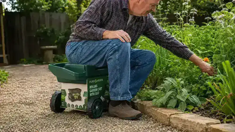 Person seated on rolling garden cart scooting along the length of a garden bed while weeding